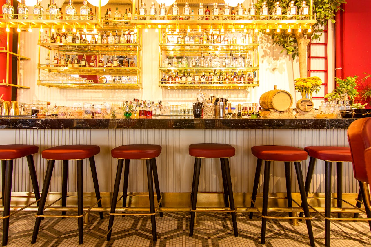 Home Sophisticated bar setup in Istanbul featuring sleek stools and a vibrant atmosphere.